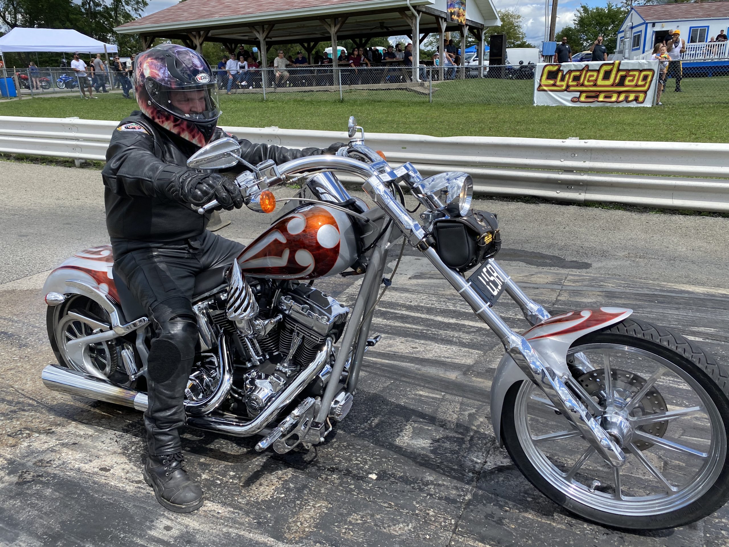 A man riding a Chopper Motorcycle