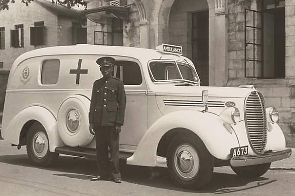 Photo : A Driver Stand Next To A Ford V8 Ambulance In Lagos In 1940