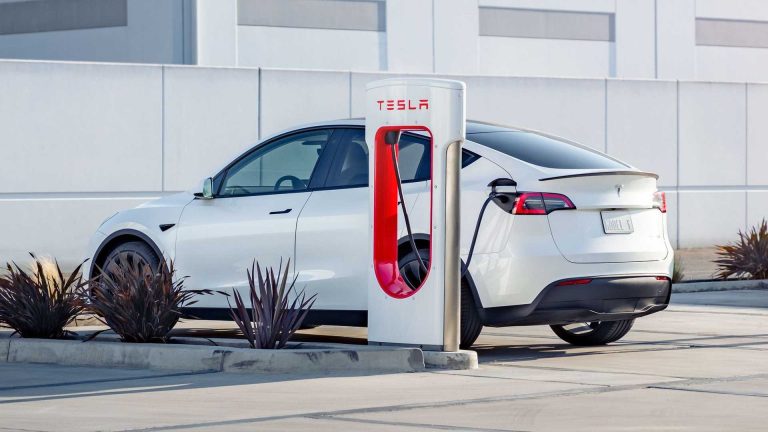 A Tesla Model Y Getting Charged At A Tesla Charging Station