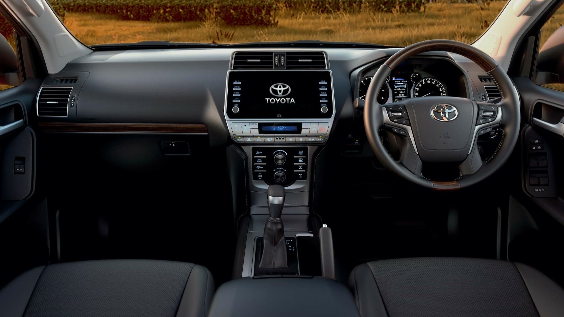 The Interior, Steering, Dashboard, And Center Console Of A Toyota Hybrid LandCruiser Prado