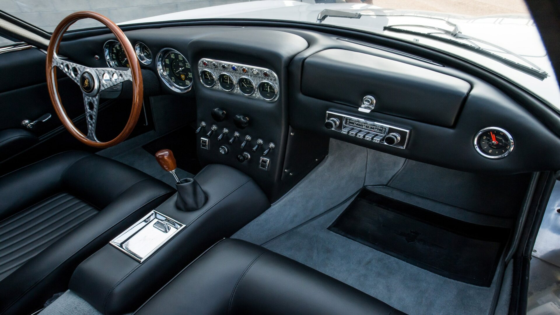 The Interior, Steering, Dashboard, And Central Console Of A 1964 Lamborghini 350 GT