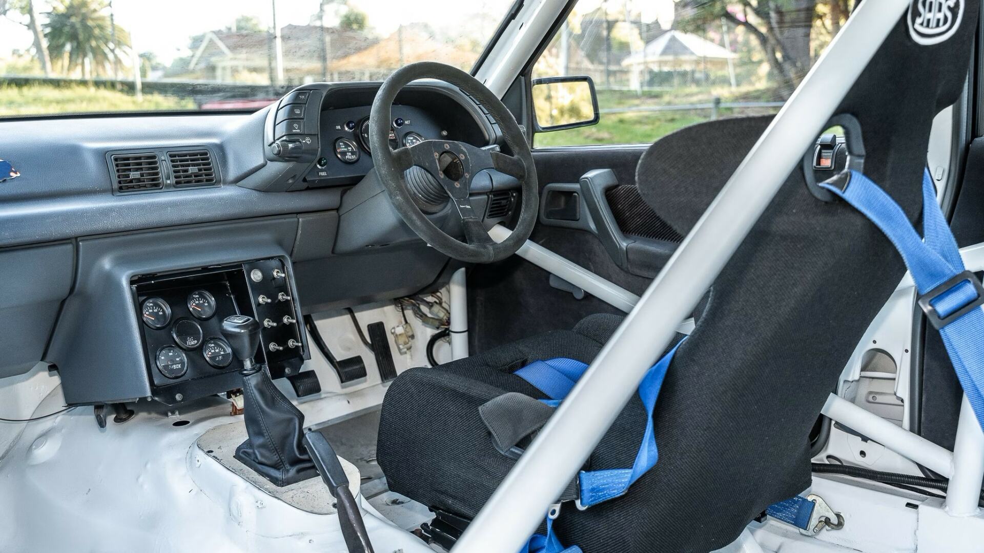 The Interior, Steering, Dashboard, And Central Console Of The 1990 Holden VN Commodore