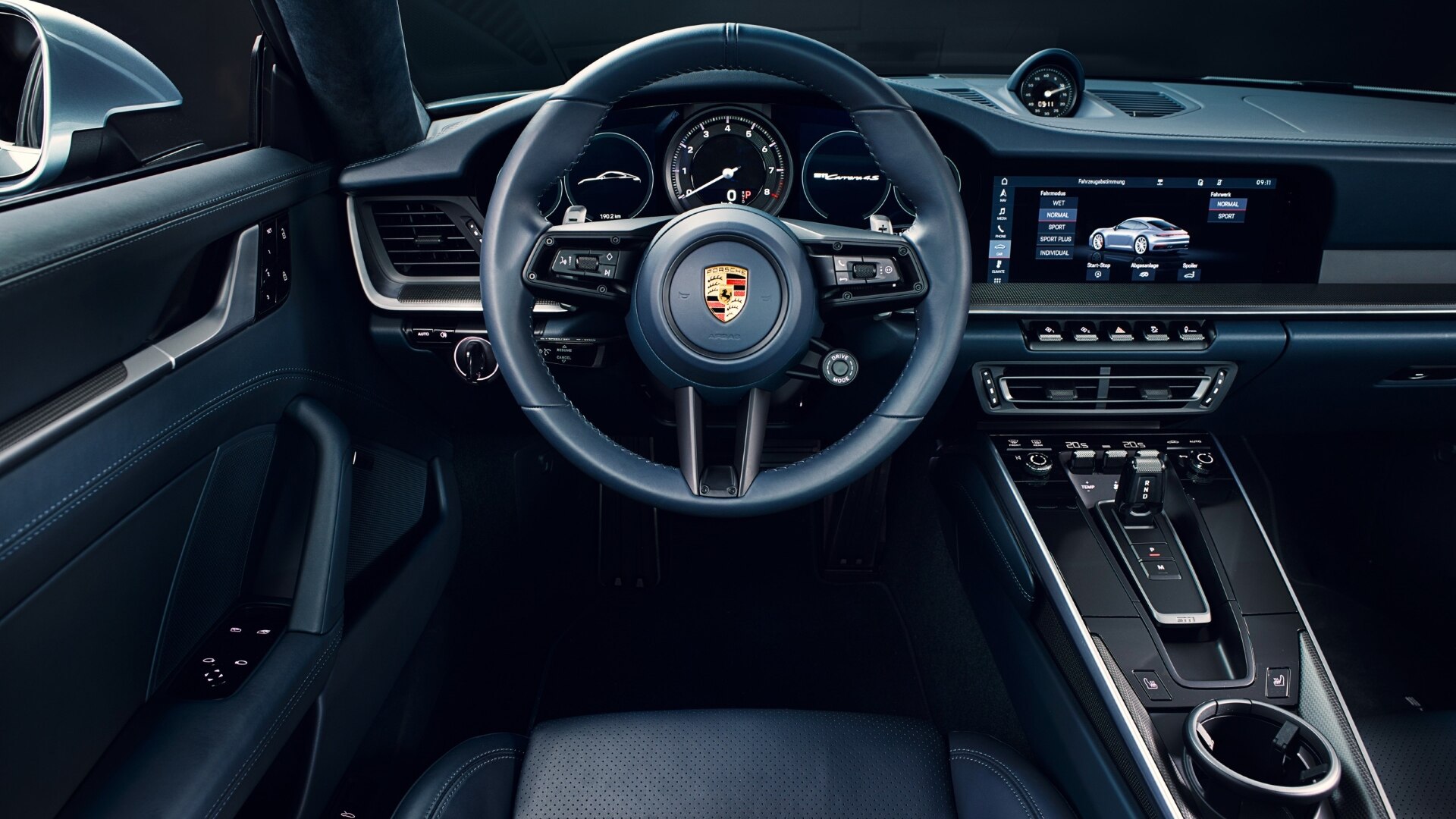 The Steering And Dashboard Of A Porsche 911 Hybrid