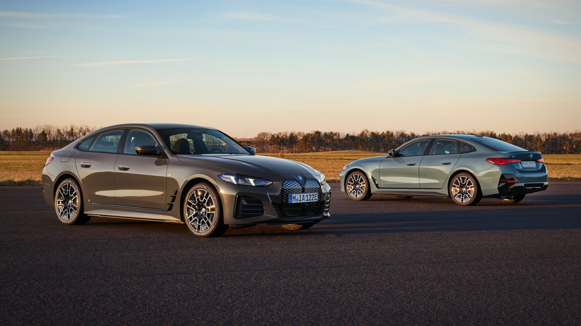 A Couple Of BMW i4s In Dravit Grey (Front) And Cape York Green (Back) Exterior Shades (Credits BMW Pressroom)