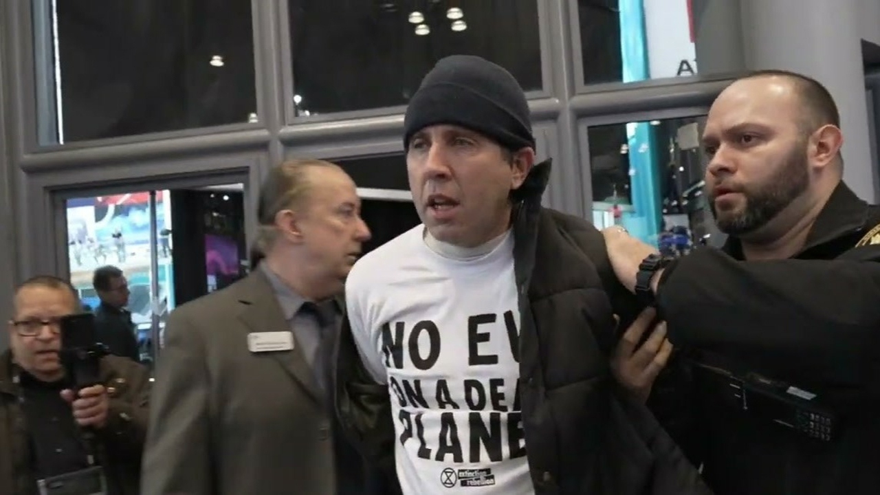 Police Escorting Climate Activists Out Of The New York Auto Show (Credits: Freedom News)
