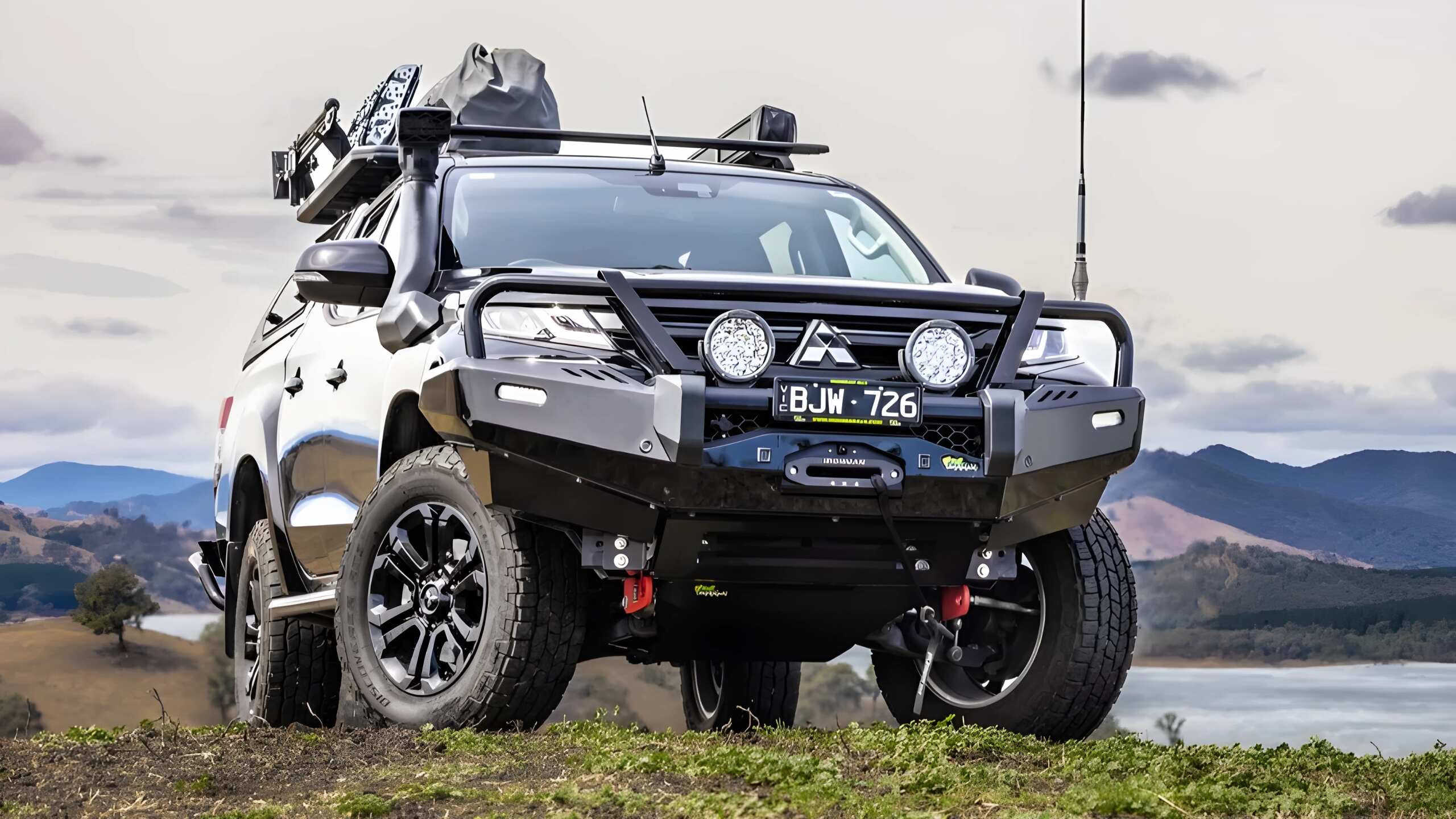 A Mitsubishi Triton Featuring An Ironman 4x4 Deluxe Bull Bar - Exterior Shade Sterling Silver