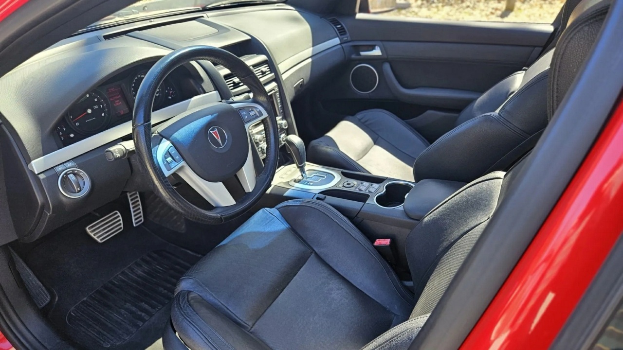 The Interior, Steering Wheel, And Dashboard Of The 2009 Pontiac G8 GT (Credits Bring a Trailer)