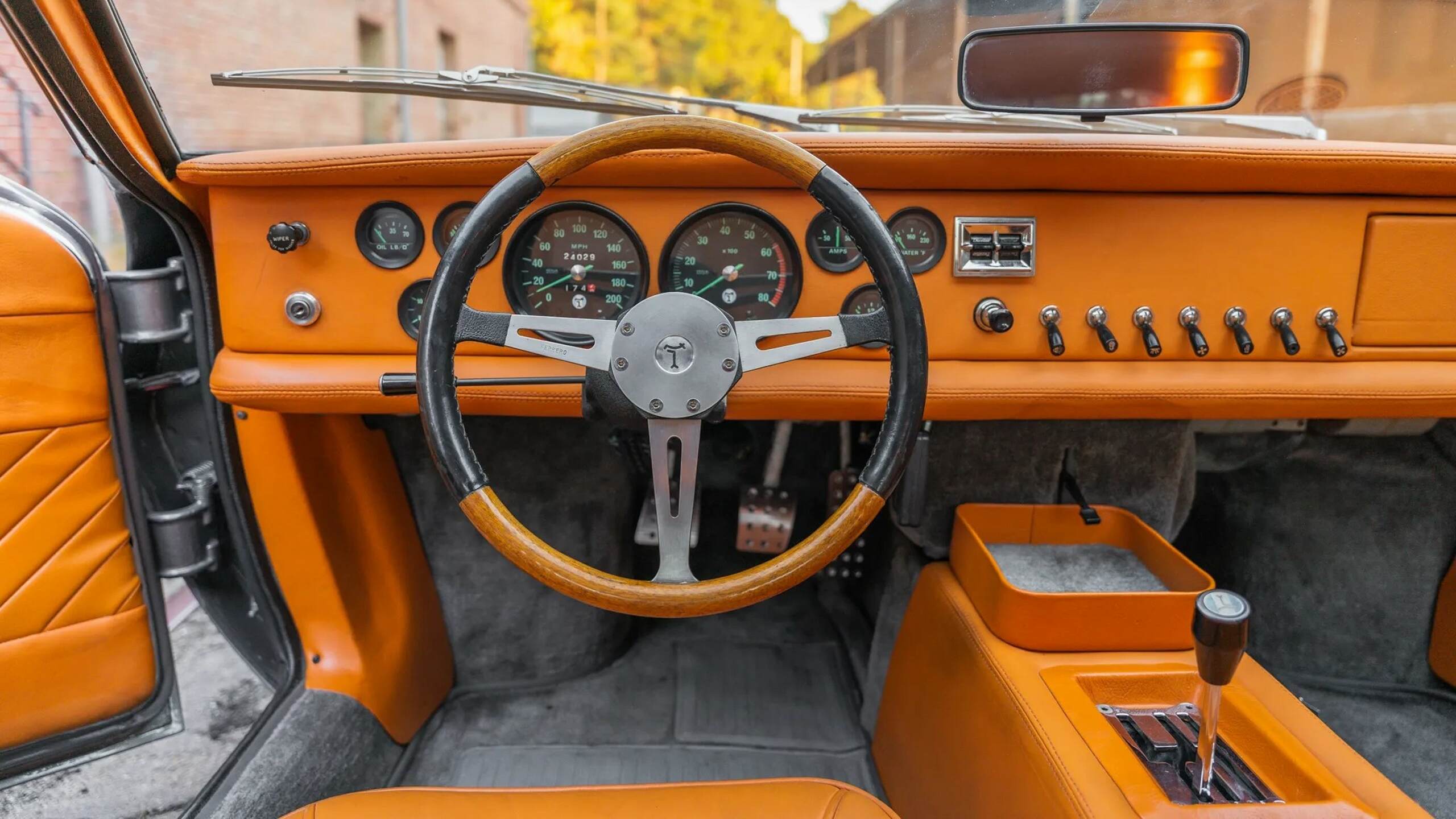 The Steering Wheel, Dashboard, And Center Console Of The 1969 DeTomaso Mangusta