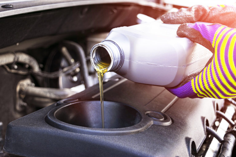 Change The Oil. Hand Mechanic In Repairing Car. Close Up Oil For