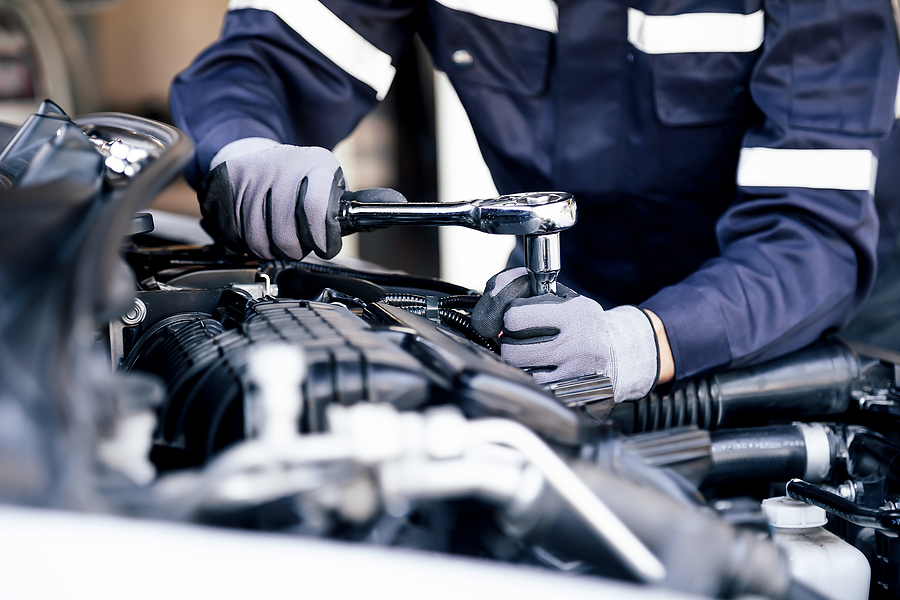 Professional Mechanic Working On The Engine Of The Car In The Ga