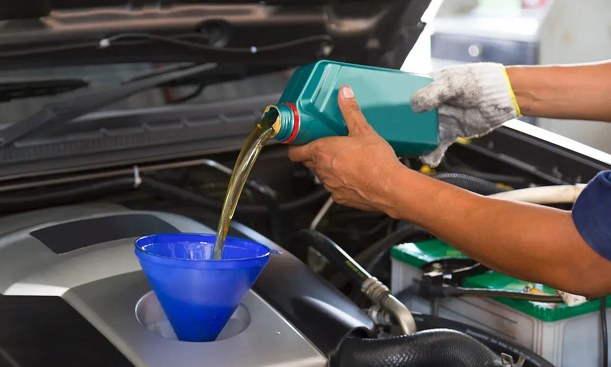 A mechanic performing a car oil change