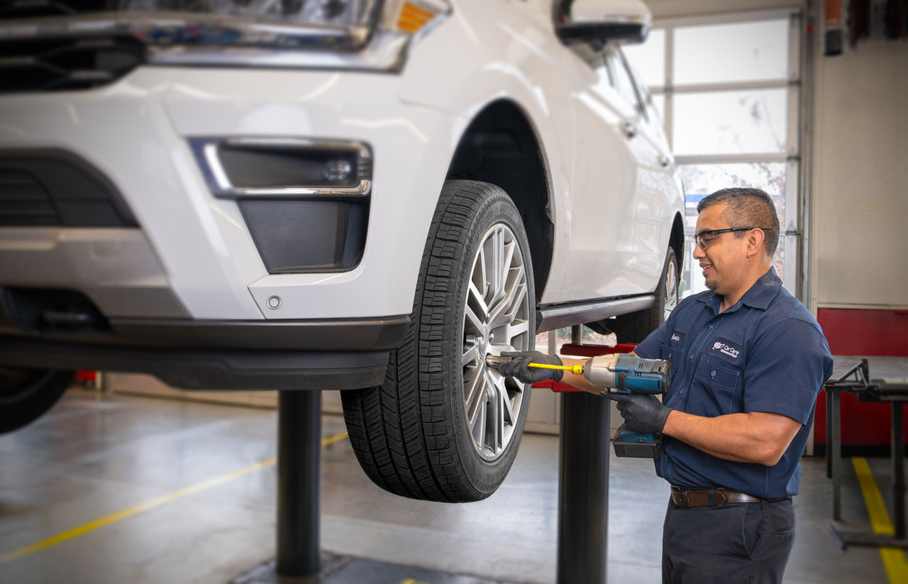 Automotive technician performing maintenance on a vehicle