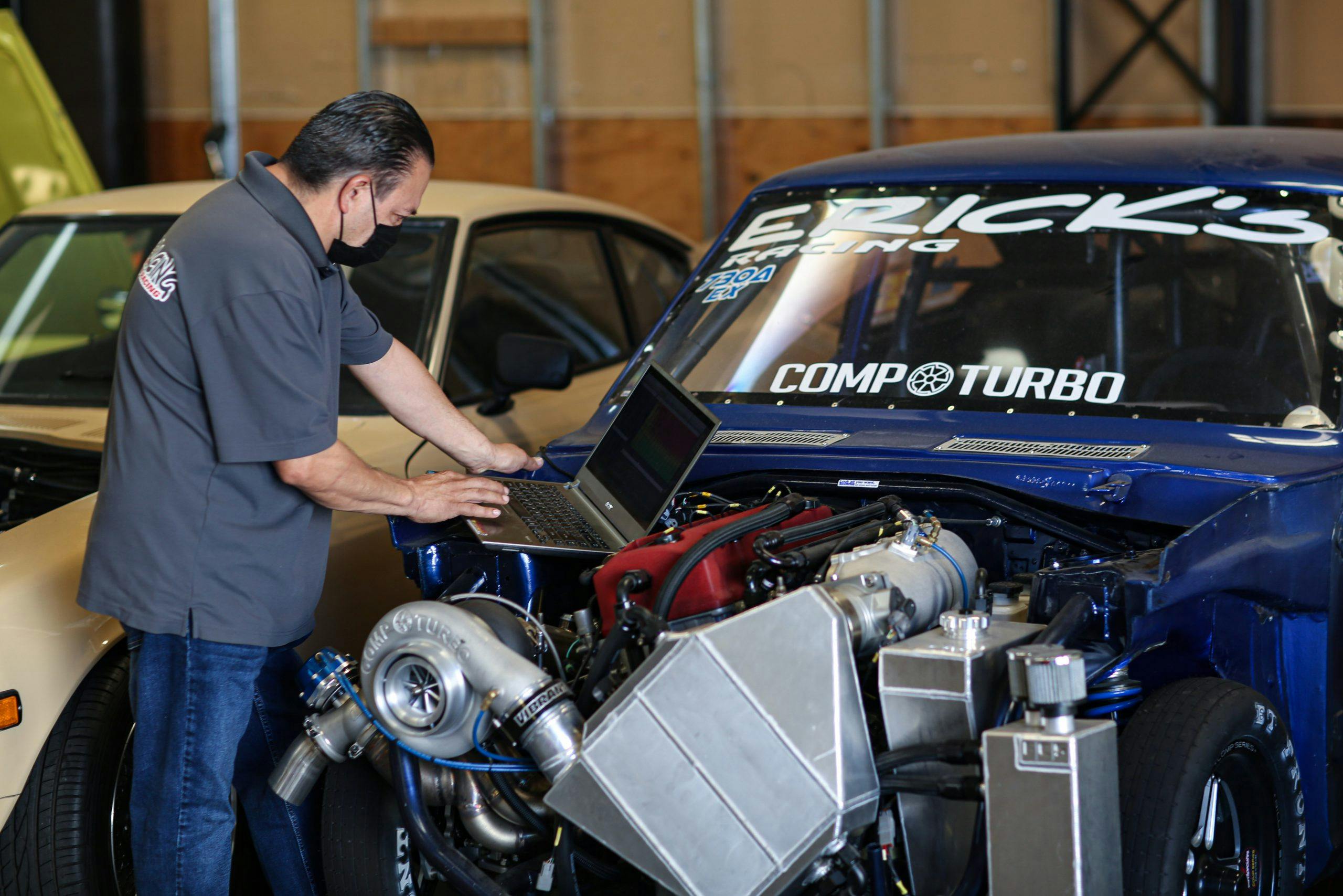 High performance racing car engine being tuned with a laptop