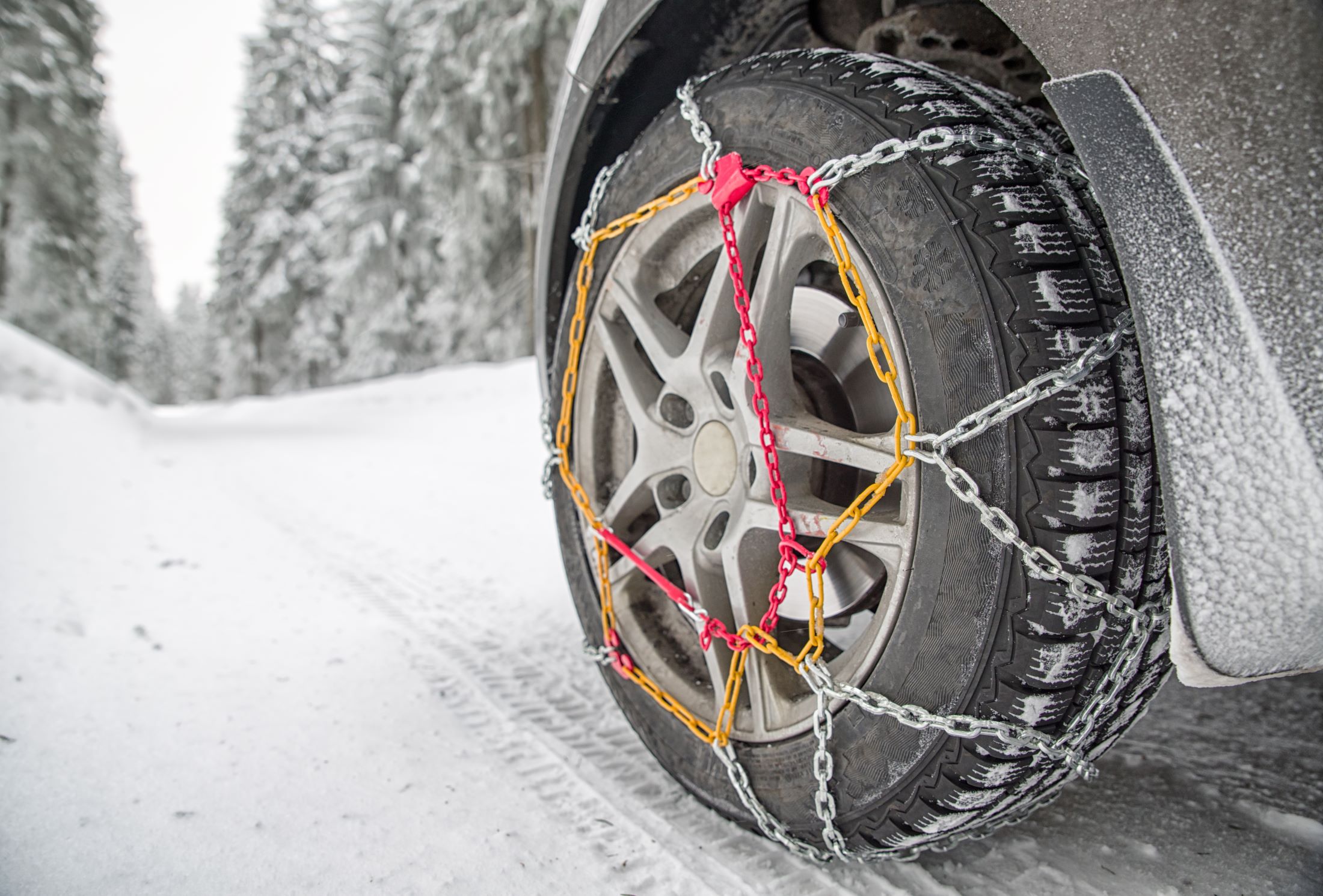 Snow chains installed on a car tire