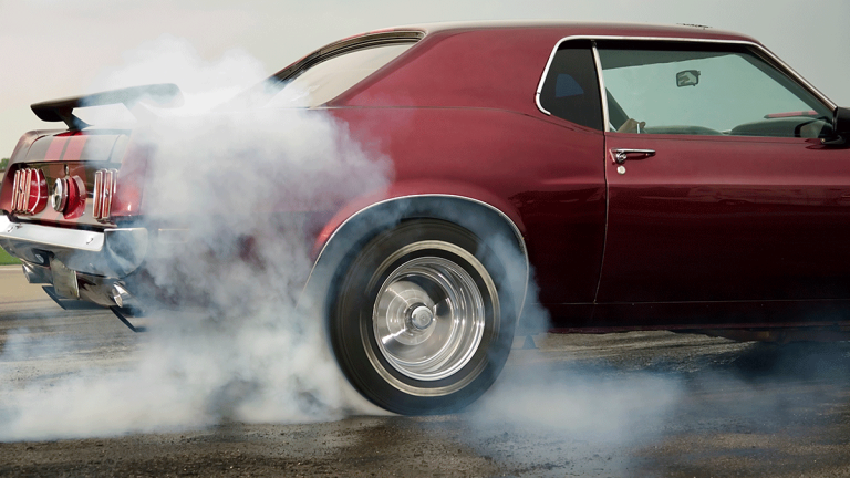 Vintage Ford Mustang engaging in a burnout