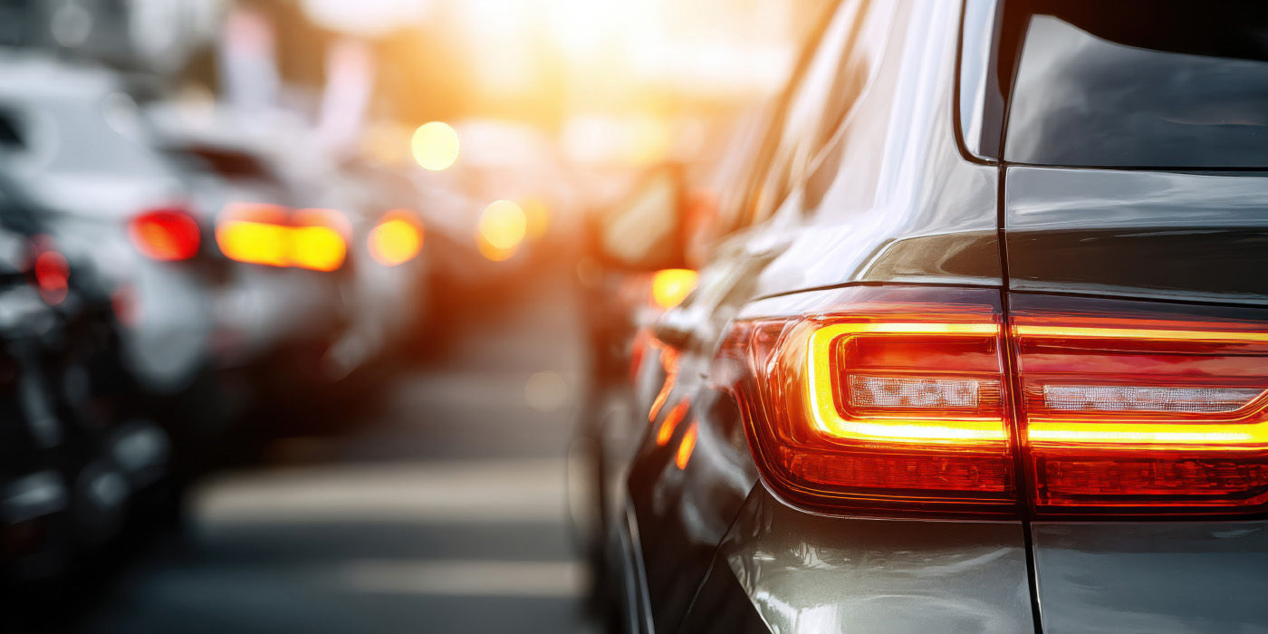 Rear taillights of a modern car, likely representing a scene of heavy traffic