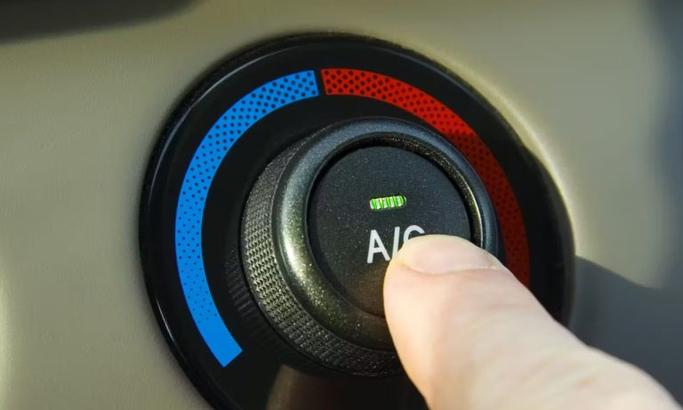 AC button on a car's dashboard
