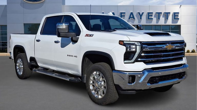 A clean white Chevrolet Silverado heavy-duty pickup truck parked in front of a dealership