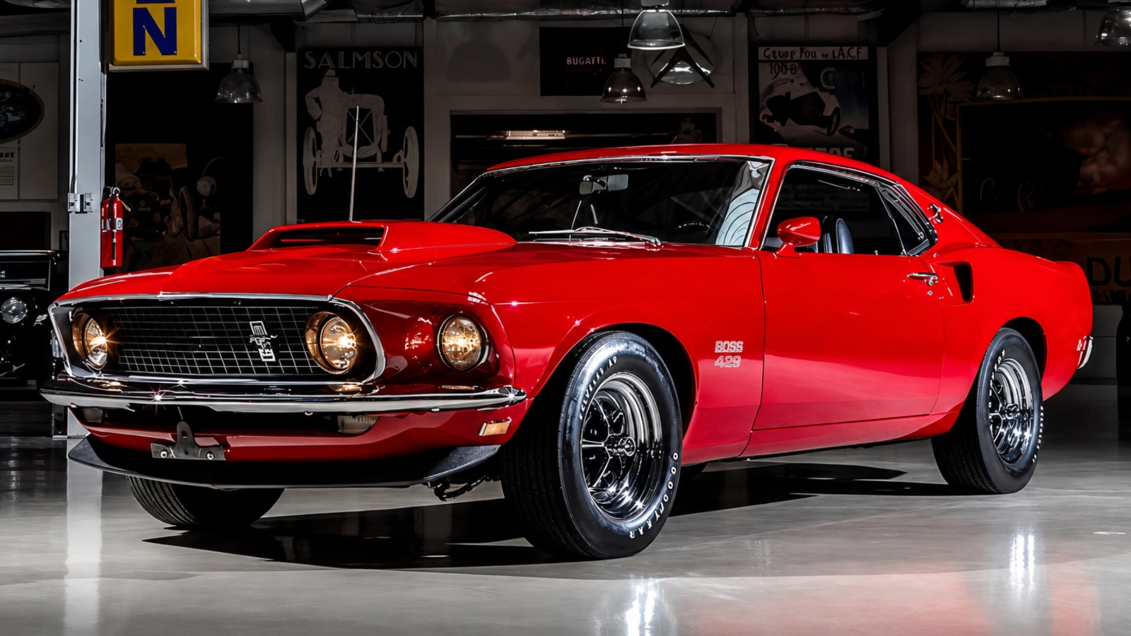 A vibrant red vintage Ford Mustang classic car parked indoors