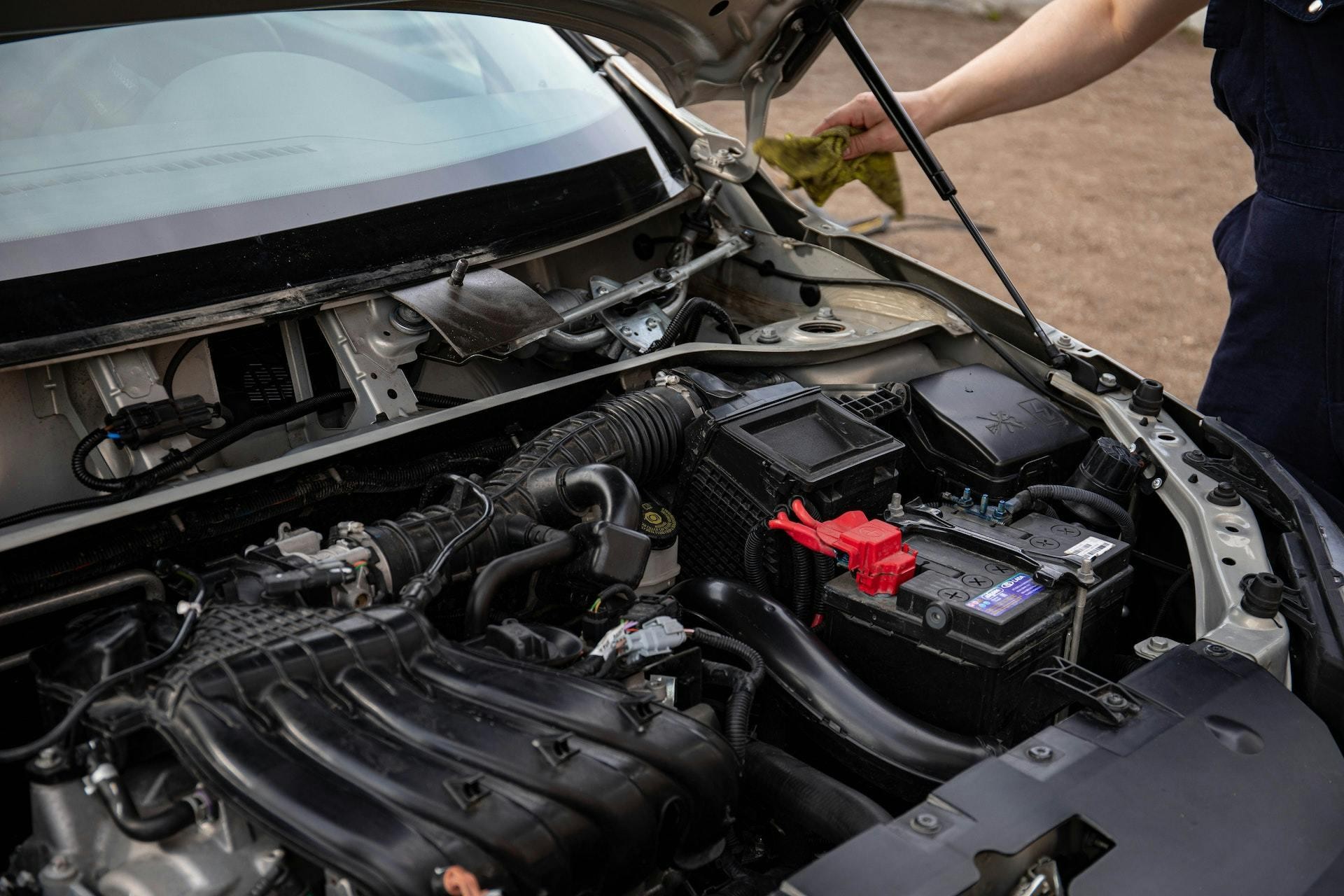 Car battery inspection under open hood