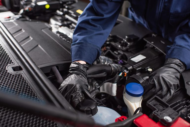 Mechanic Checking Overlooked Fluid Reservoirs