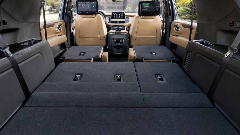 Interior view of an SUV cargo area with folded rear seats showcasing ample hauling space