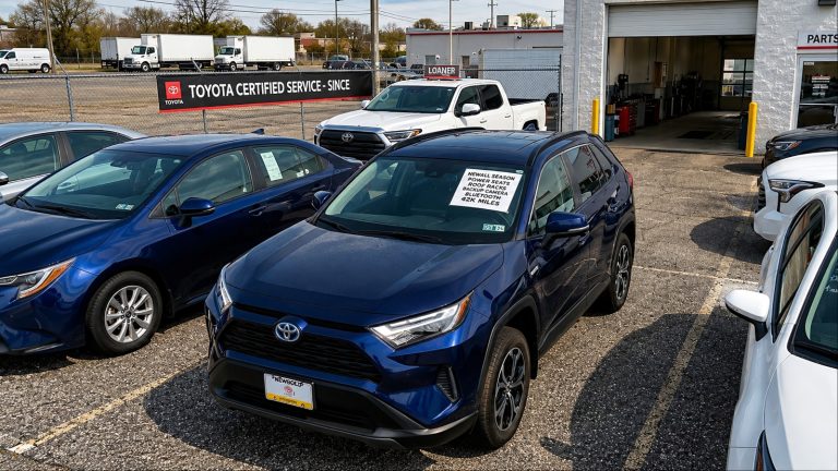 Recall-affected SUV parked outside dealership awaiting safety repairs