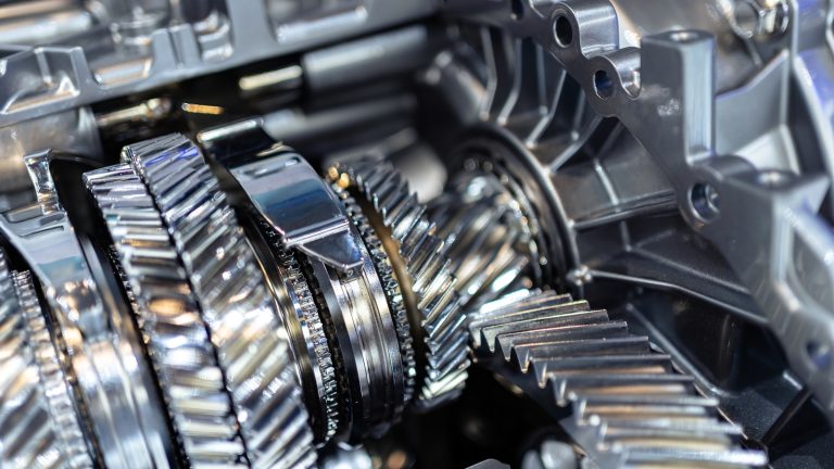 close-up view of shiny metallic gears and mechanical components inside a vehicle transmission