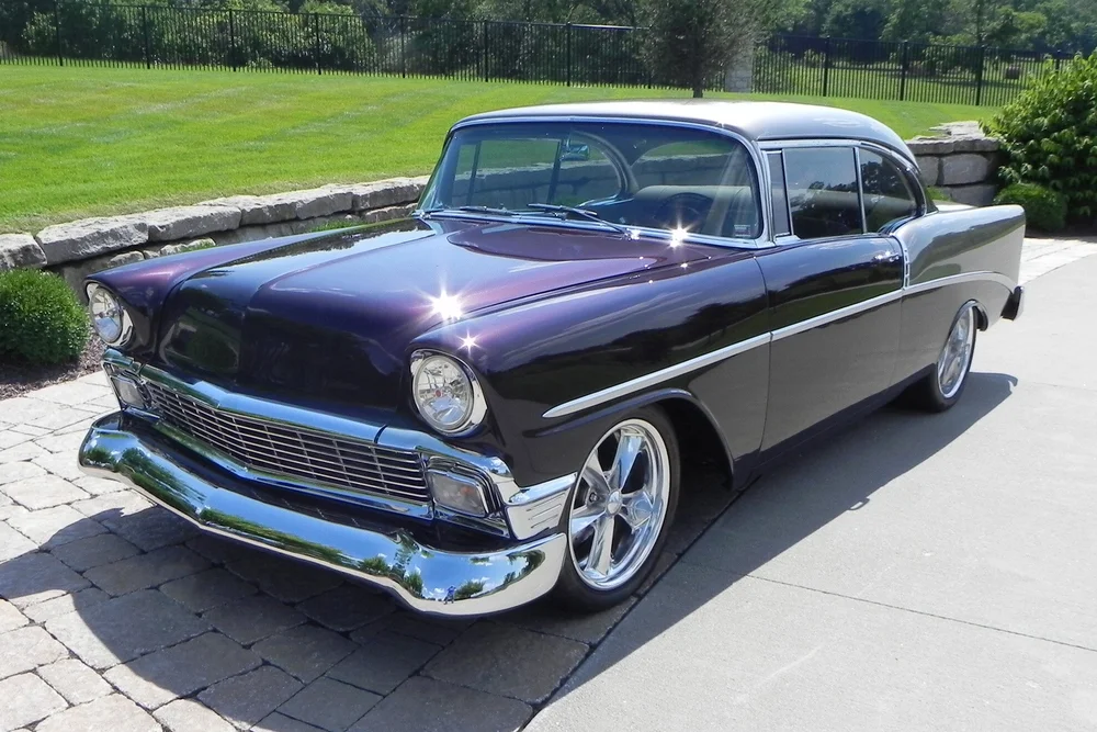 A 1956 Chevrolet "210 Custom 2 Door Coupe is standing in a parking