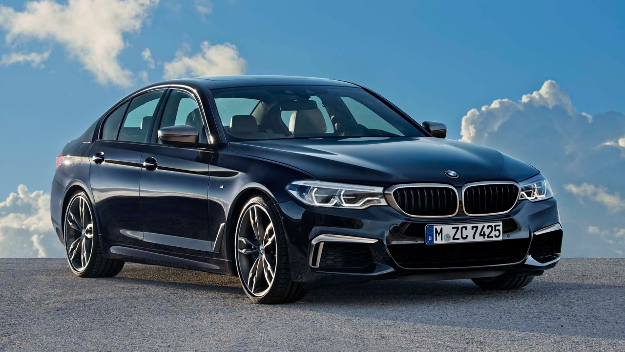 2018 BMW 5 Series (G30) parked beneath a clear blue sky