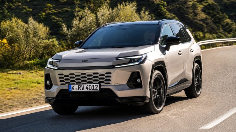Silver Toyota RAV4 SUV driving on a winding coastal road