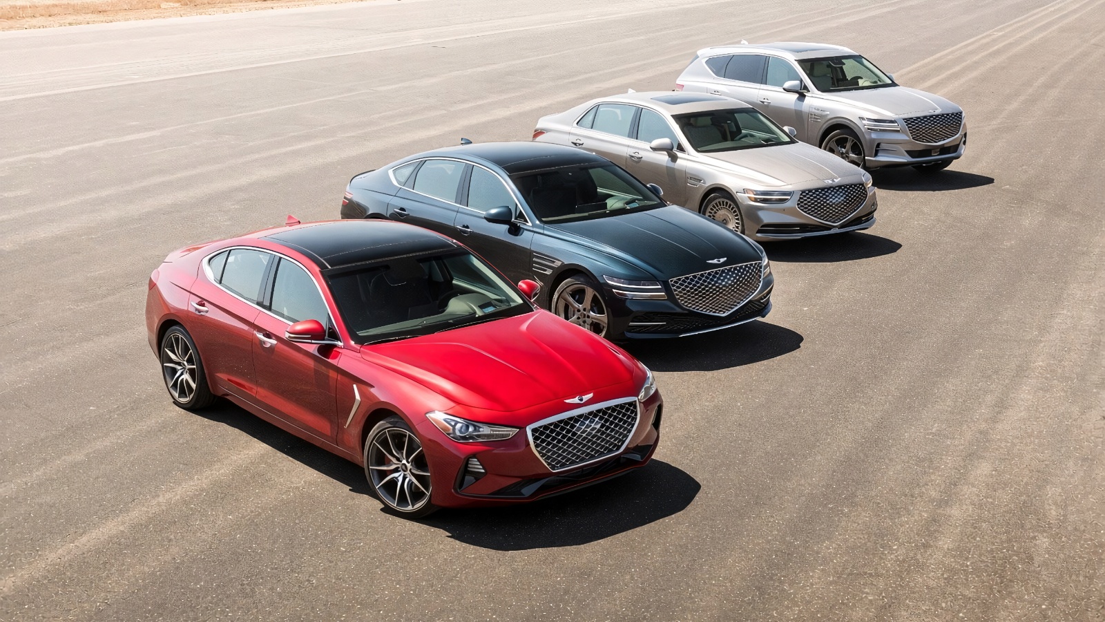 Four different Genesis cars and an SUV parked sequentially on an open tarmac surface