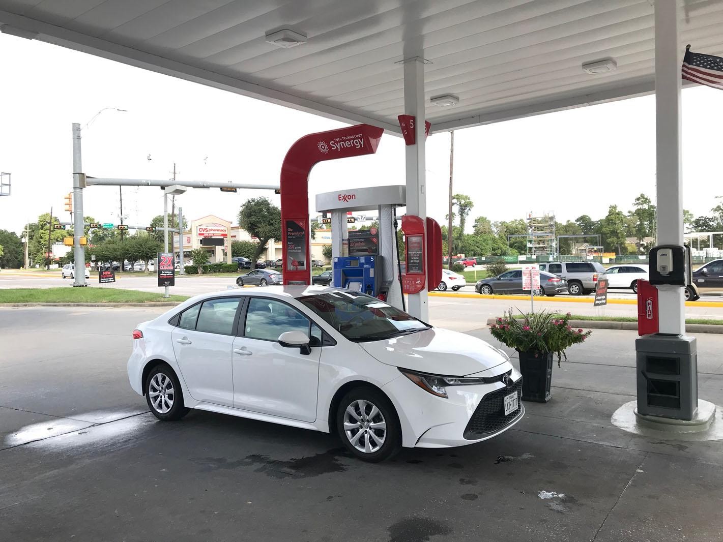Fuel-efficient sedan at gas station pump