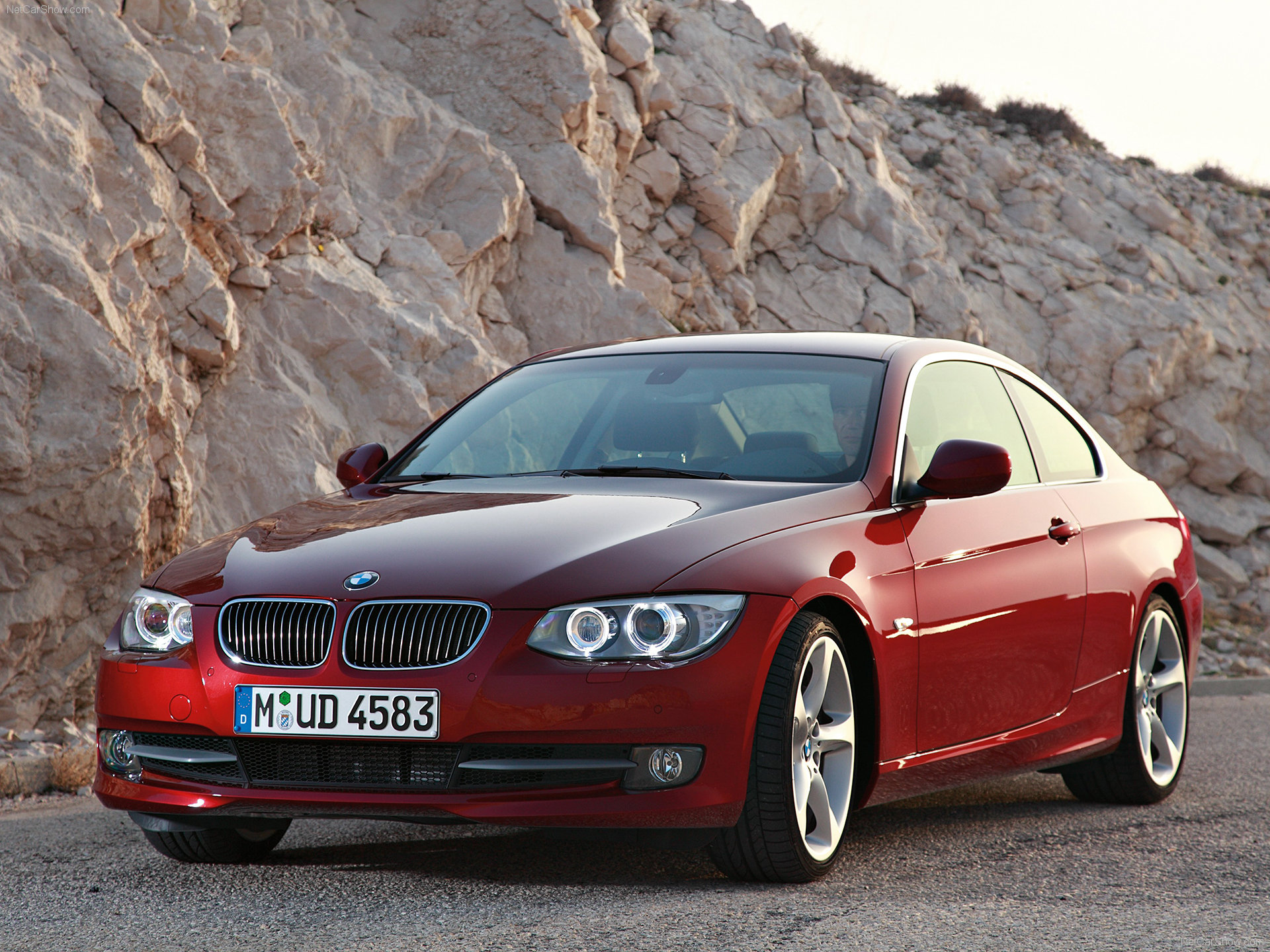 A BMW 3 SERIES is standing on a hilly region