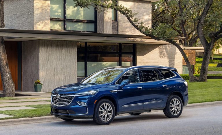 Modern Buick SUV parked in a suburban driveway during golden hour