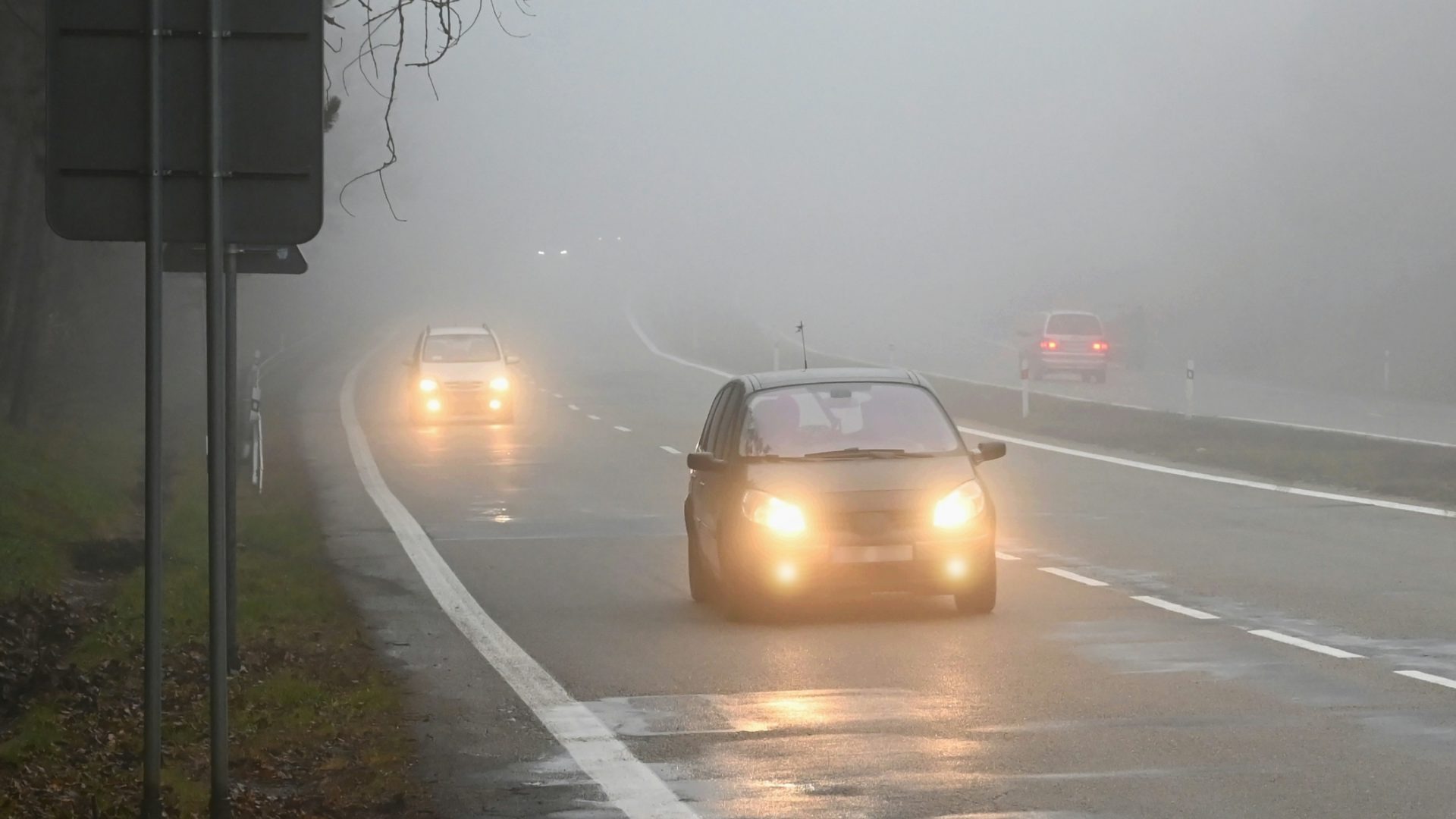 Cars driving along a wet highway