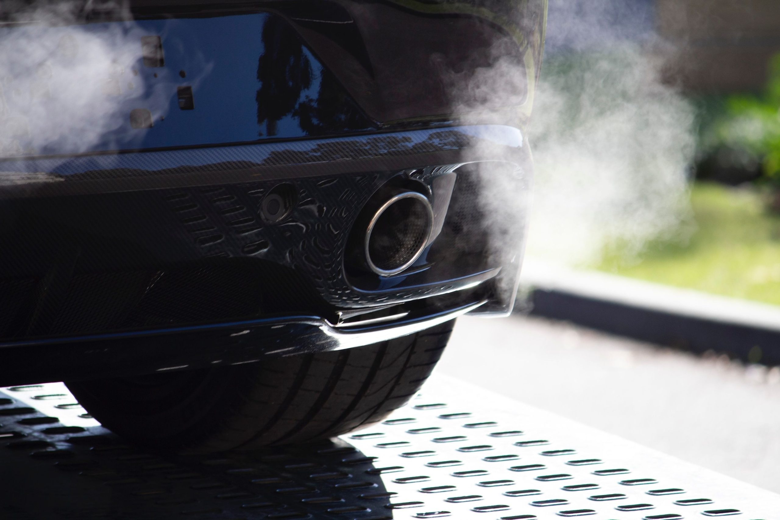 Car's exhaust pipe emitting white smoke