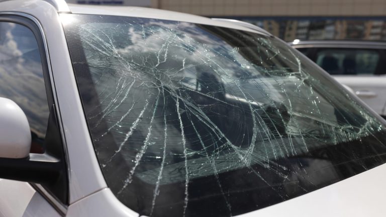 Cracked windshield with extensive impact damage affecting driver visibility