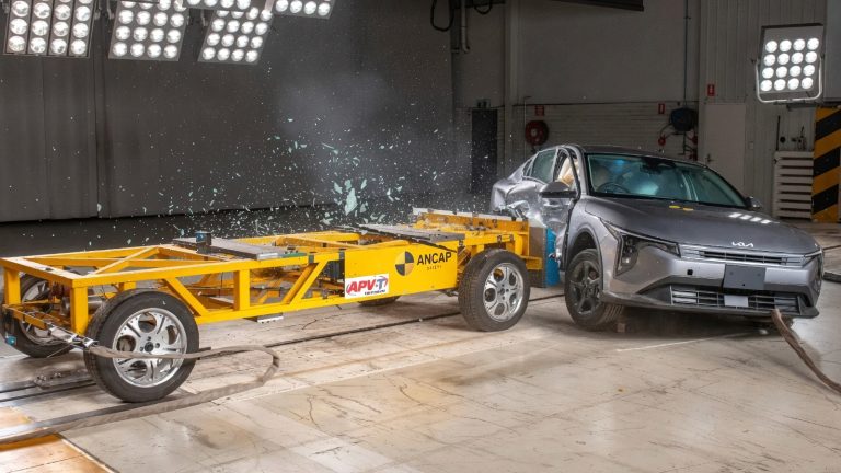 Crash test showing an electric vehicle's battery pack separating from the body during impact