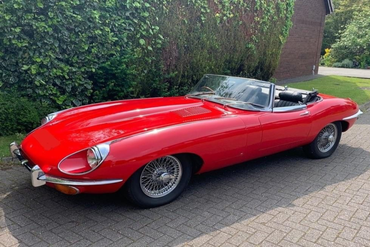 e-type jaguar parked in the parking area of a house