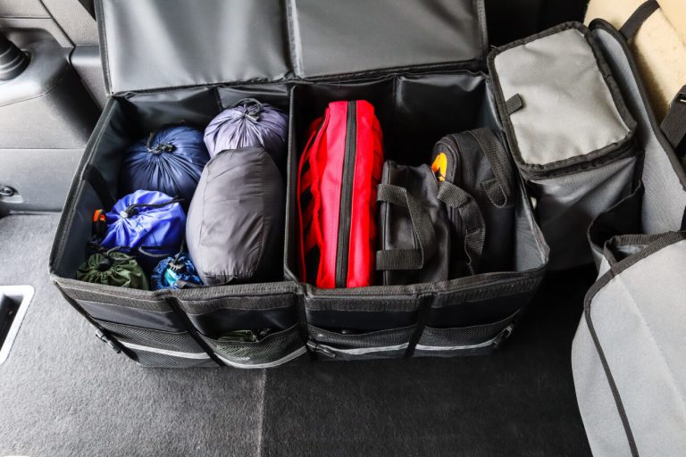 Two toolkits filled with tools in a car