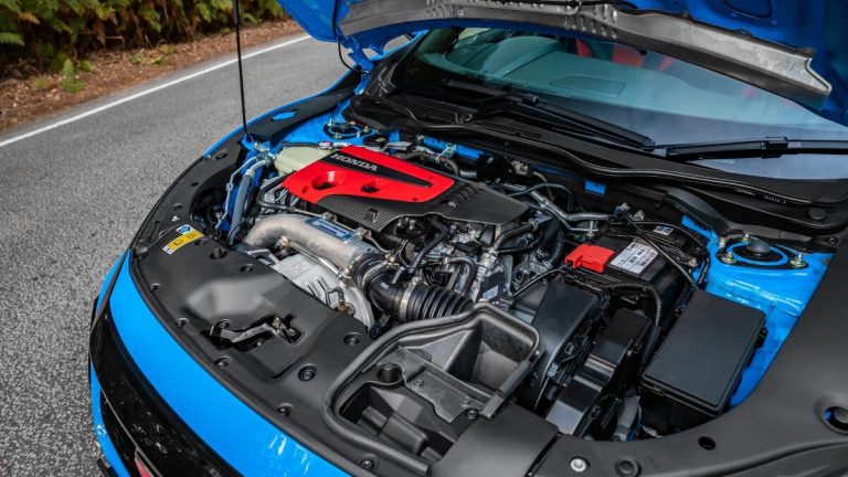 An engine is shown in the car with blue hood