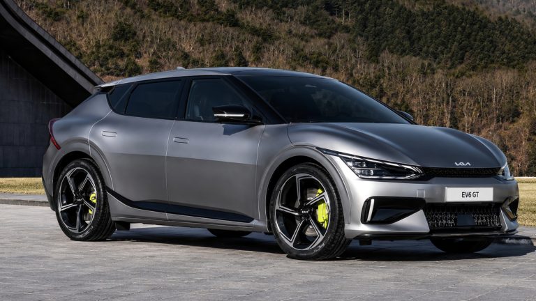 Kia EV6 GT parked against a scenic mountain backdrop