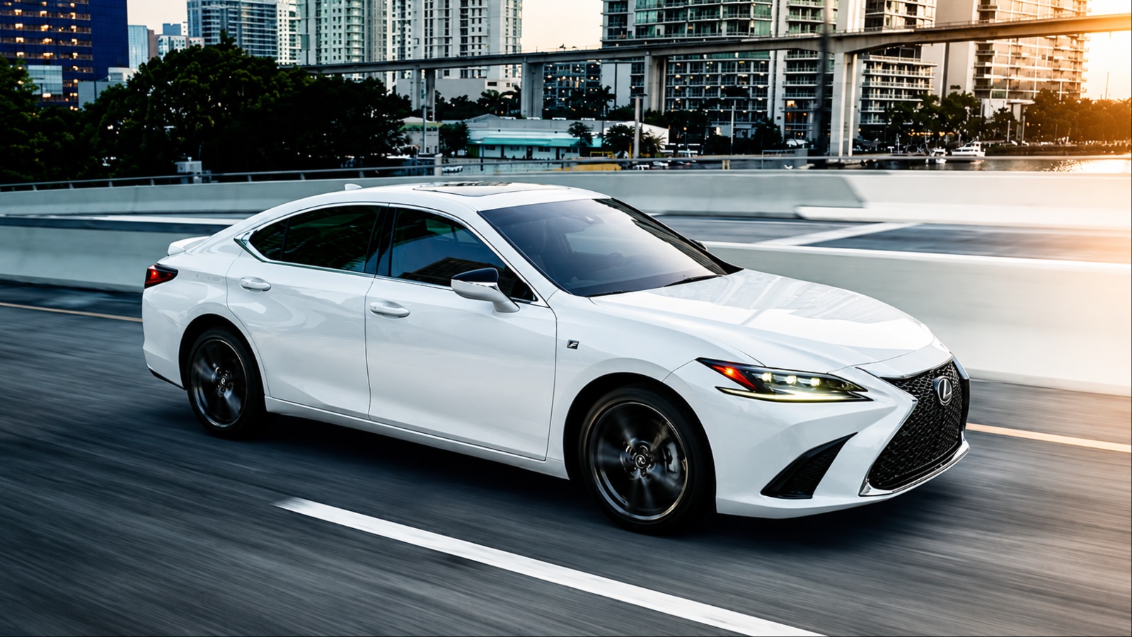A white Lexus ES sedan drives along an urban highway, with city buildings in the background