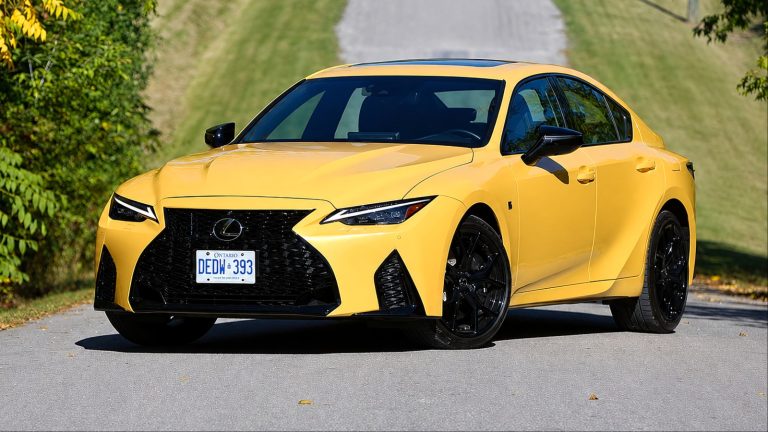 bright yellow Lexus sedan parked on a sunny paved road