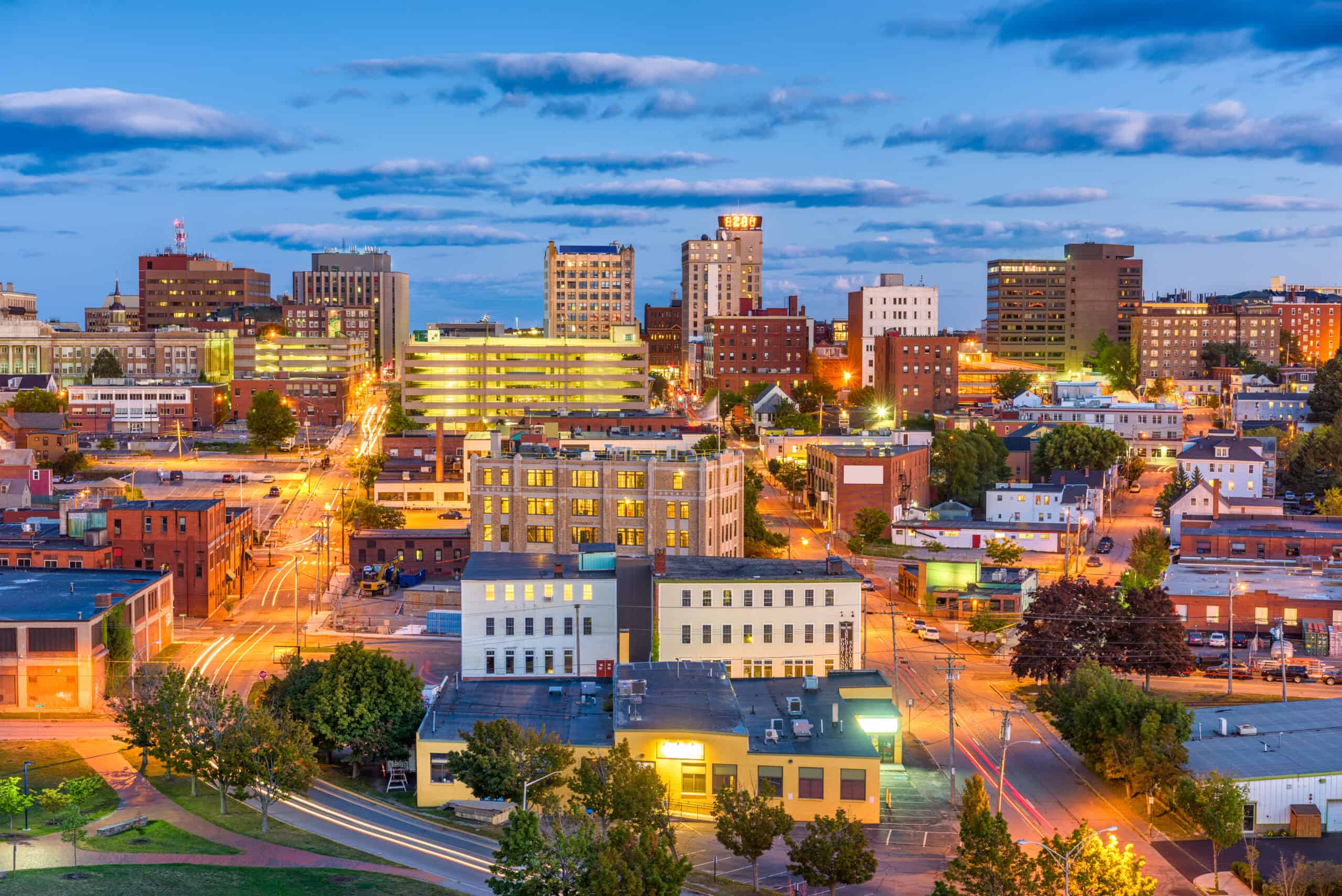 High-angle dusk panorama of Portland skyline with illuminated buildings