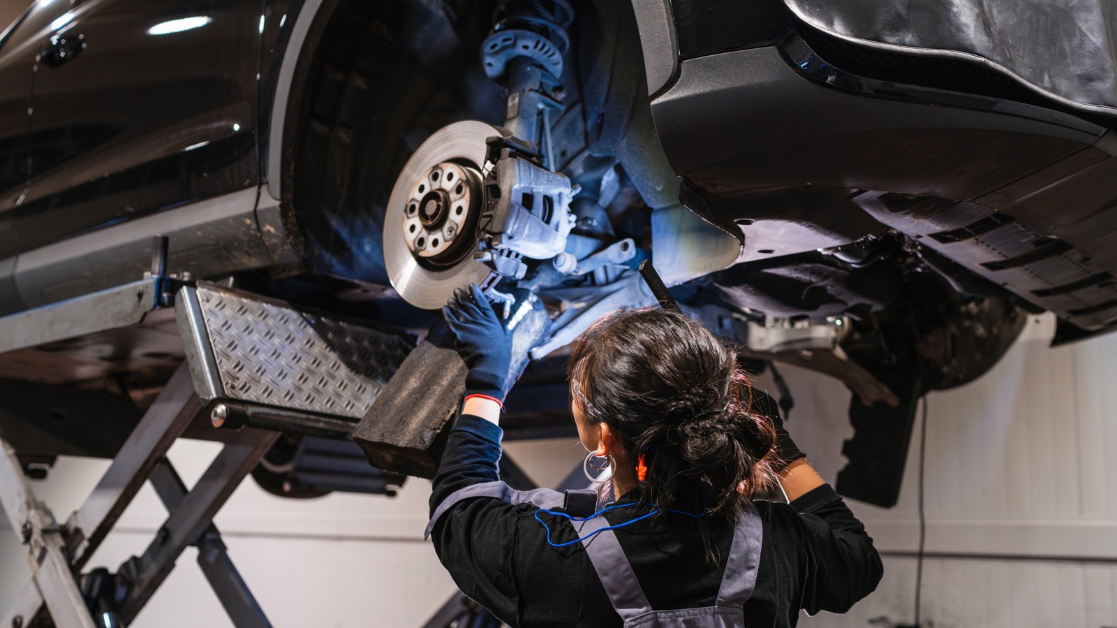 Mechanic inspecting a vehicle's disc brake system