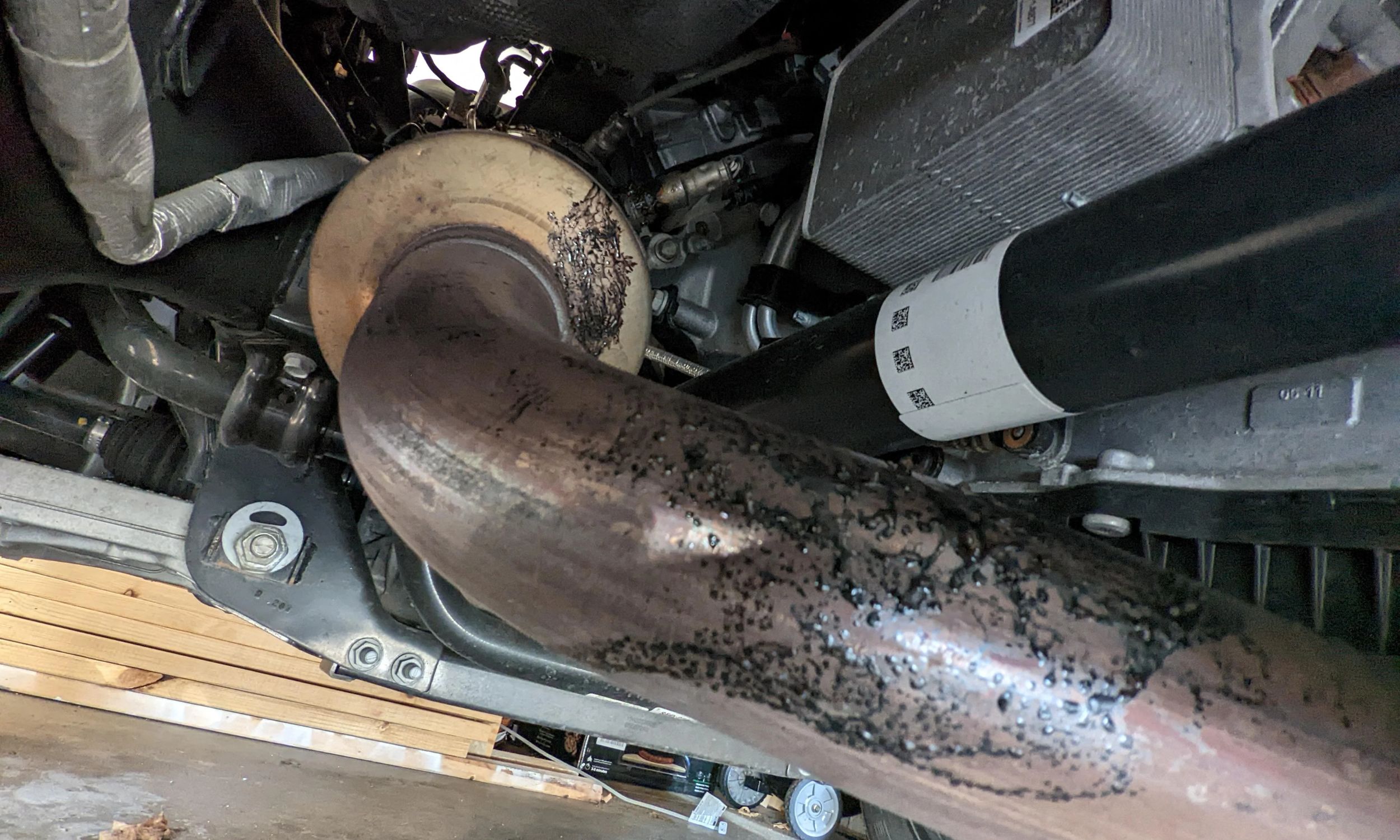 Melted plastic stuck to the hot exhaust pipe