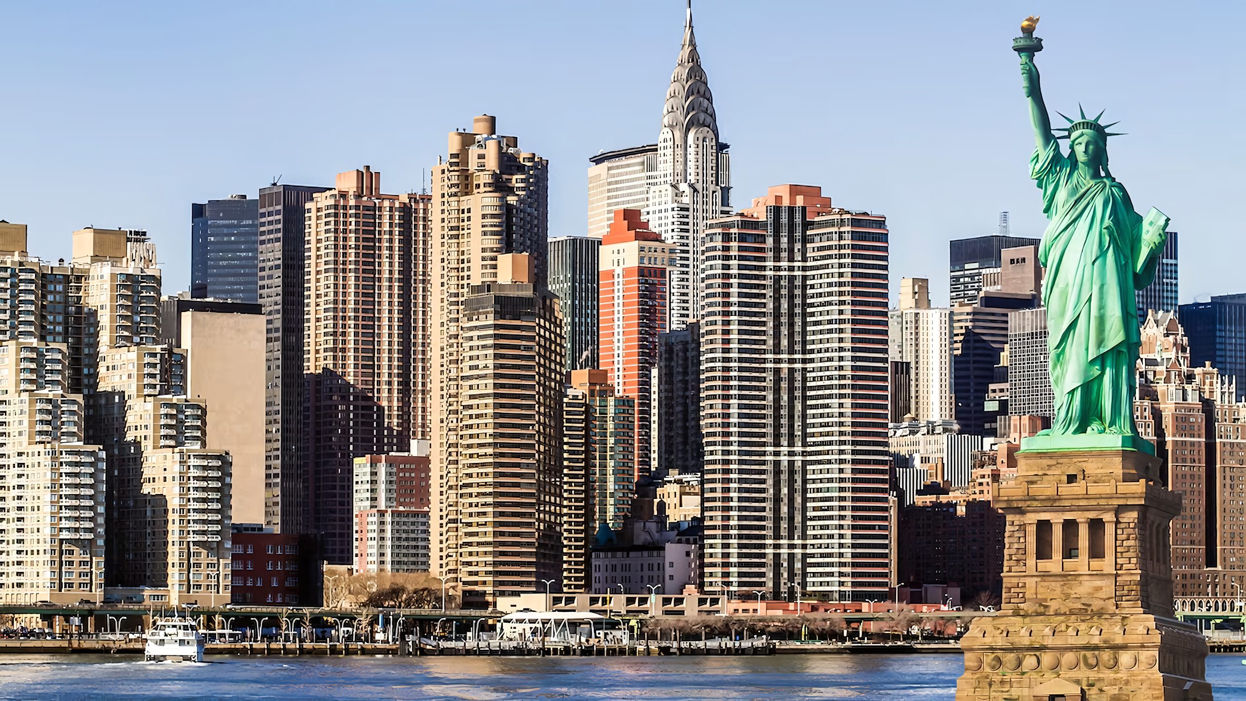 Statue of Liberty stands prominently before a New York skyline