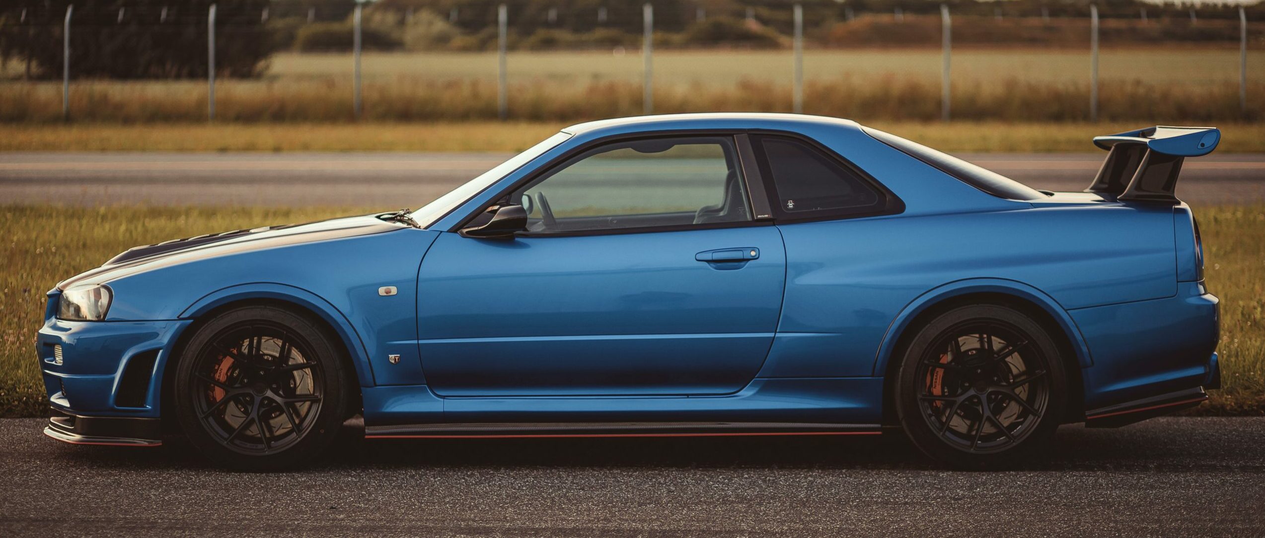 A Nissan GTR is speeding on a highway